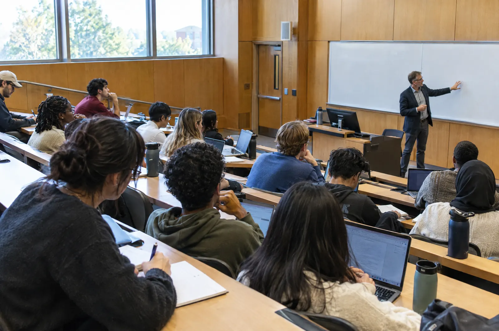 A professor teaching in a university lecture hall